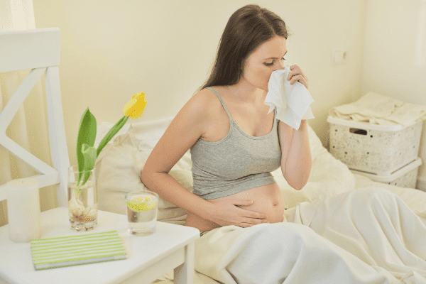 sick woman while pregnant with nasal congestion