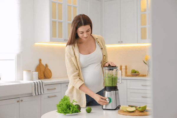 pregnant woman making smoothie instead of drinking soda